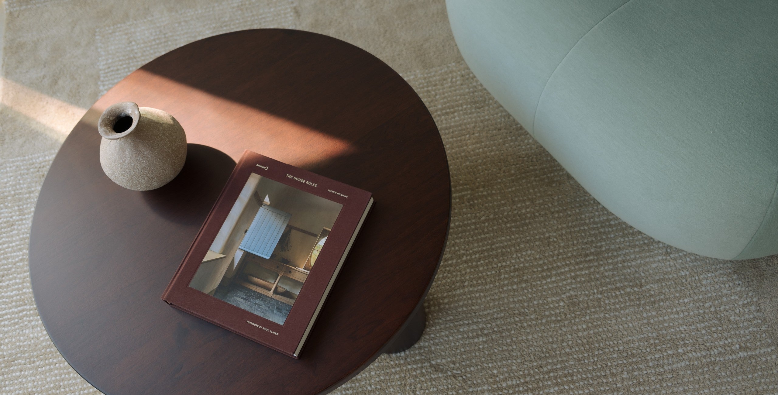 Mieux Gami round solid walnut coffee table styled with vase and book