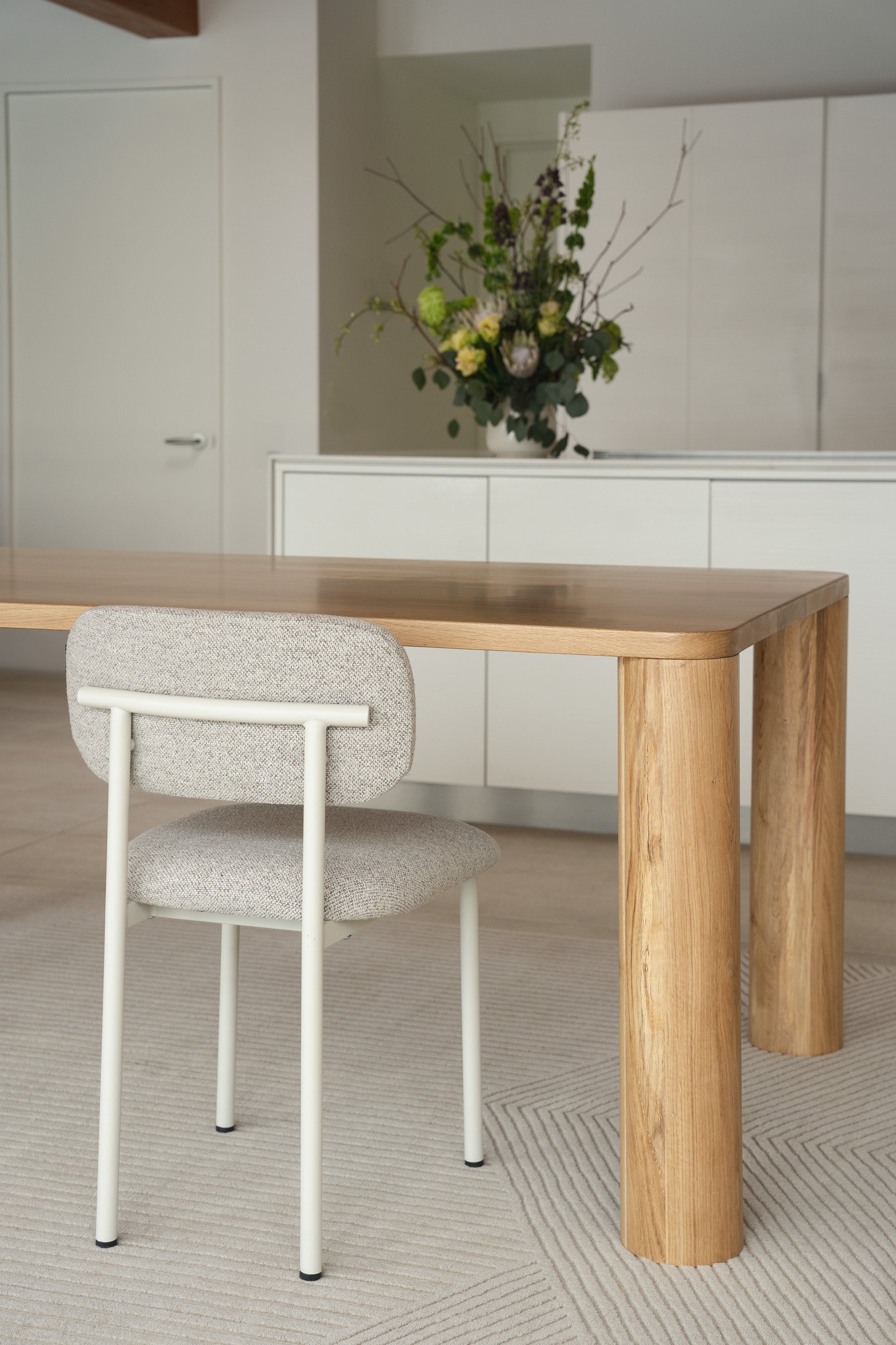 Mieux Tema oak dining table and Ray dining chair displayed in a modern dining room setting