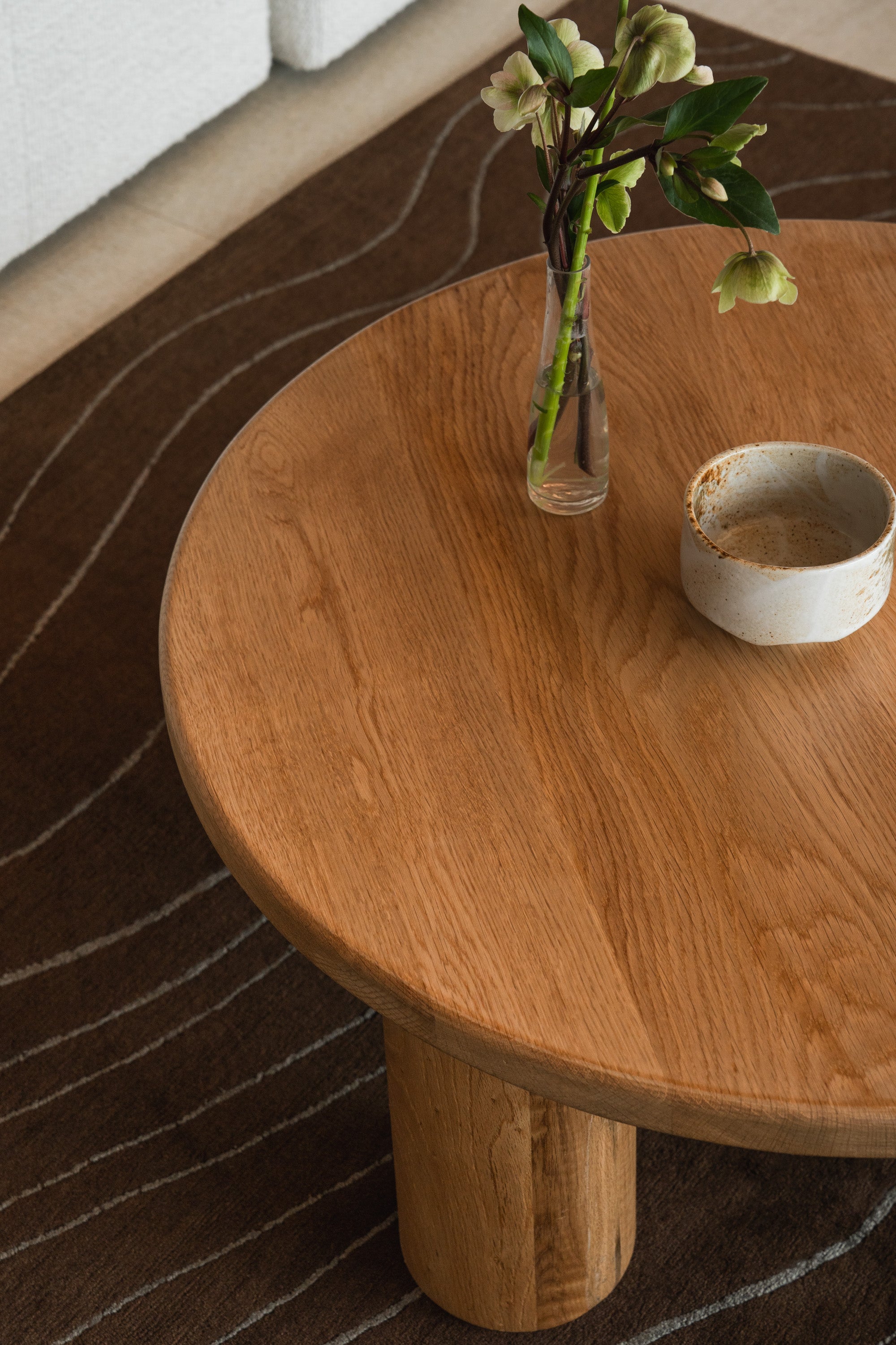 Close-up of Mieux Gami oak coffee table in a modern living room with neutral tones and cozy styling