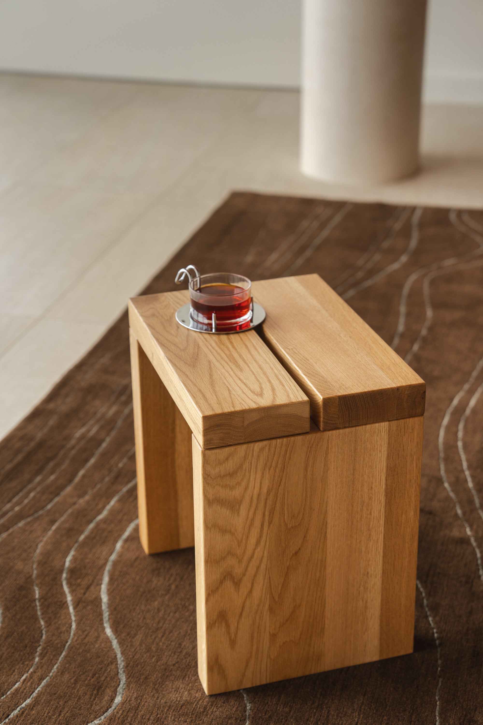 Mieux Lyster oak stool displayed in a modern living room setting