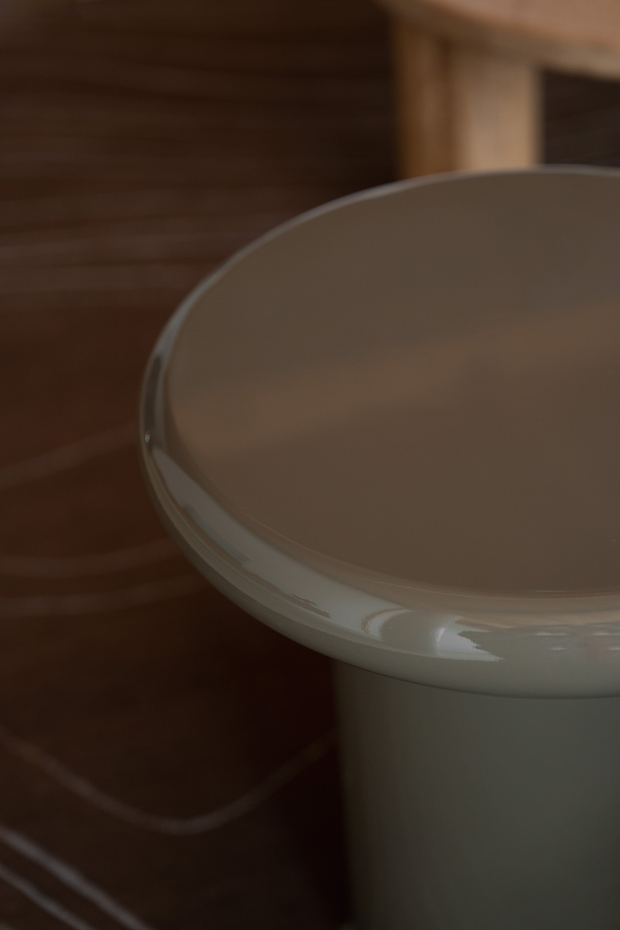 Close-up of Mieux Mile side table in olive gloss finish in a modern living room